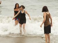 Mikayla, Camille, and Carmen dodging the waves