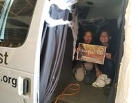Victor and Luisa building the haunted youth van for Trunk or Treat event