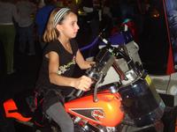 Chloe riding the hog at Boomers