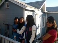 The girls watching the batting cage