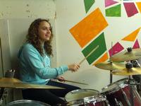 Donya playing drums for the worship team