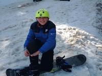 Donald strapping into his snow board