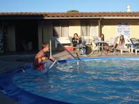 Donald riding his scooter into the pool