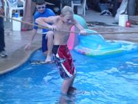 Ryan using a rope and Donald's shoulders to walk on water
