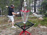 Darren going for a putt using his cheapo disc golf basket