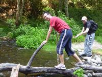 Derek crossing the log with a little help from Jon-Michael