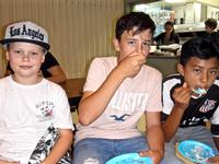 boys enjoying chocolate ice cream cake